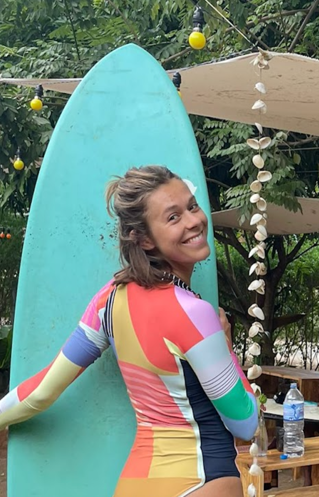 mira frischhut, founder of heeru, with a surfboard